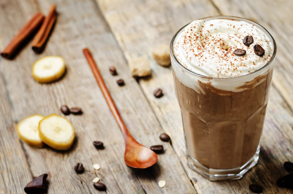 Banana Cream Cold Brew Coffee in glass on wooden table.