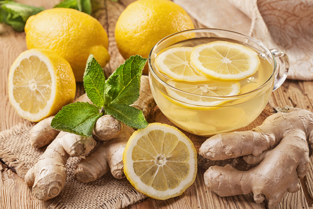 Ginger tea with lemon on a wooden table.