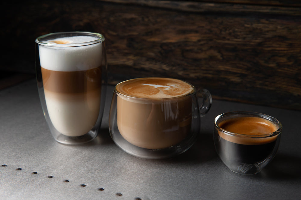 Three types of coffee, Cappuccino, Latte, espresso. On a dark background.