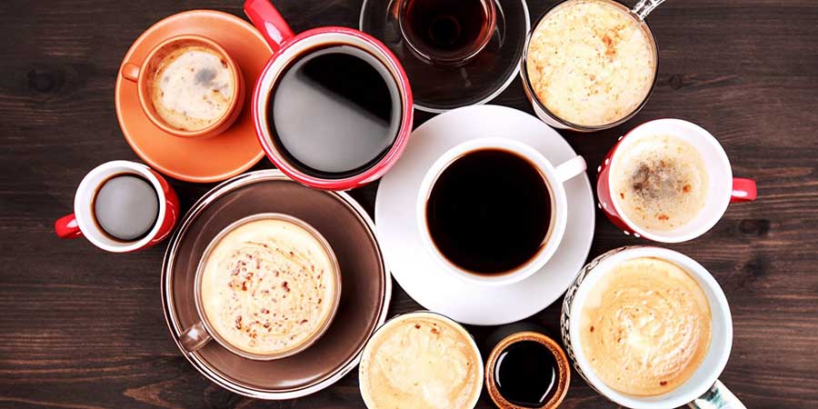 Photo of different tea cups and saucers filled with different types of coffee drinks.