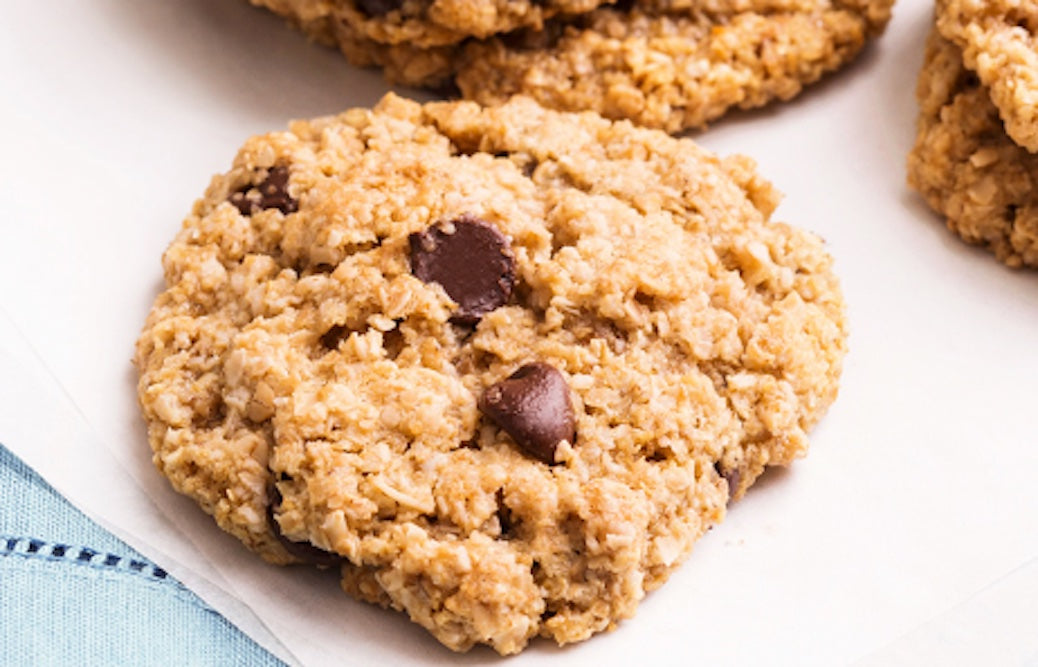Chocolate chip cookies on a white napkin.