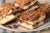 Closeup of a pile of sliced cinnamon streusel coffee cake on a plate.