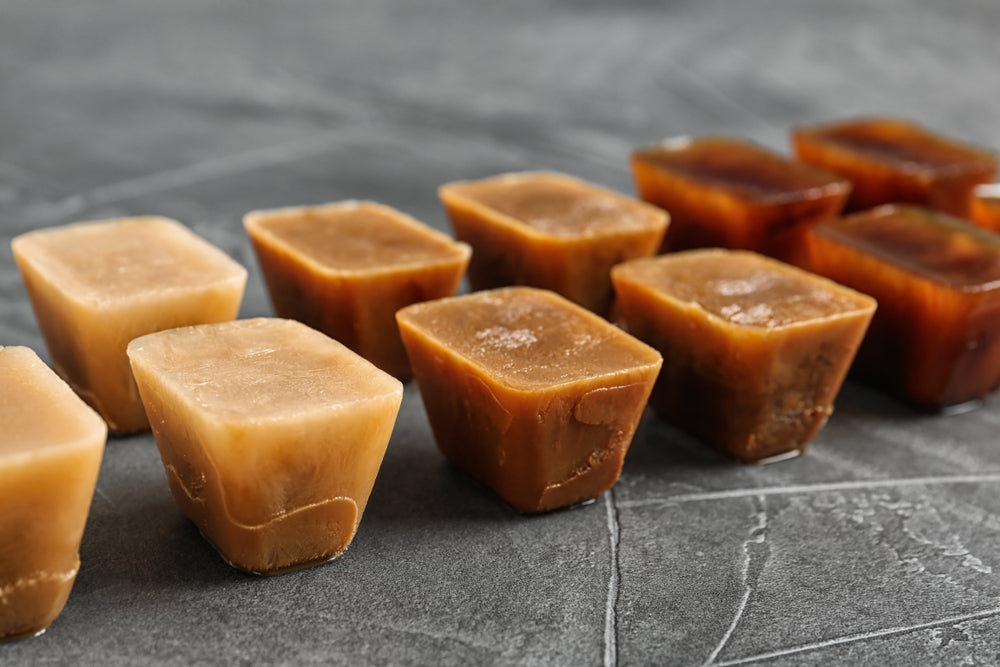 Coffee ice cubes on grey table.
