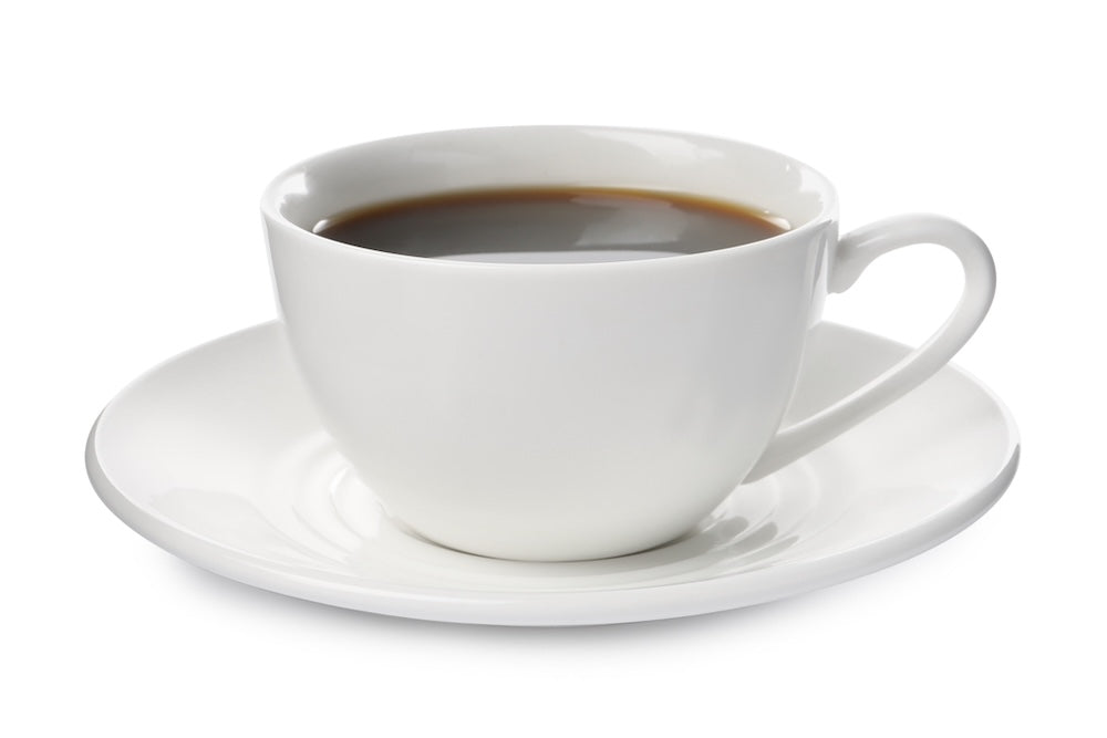 White cup and saucer filled with black coffee.