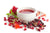 Cup of pomegranate green tea isolated on white background with parts of a pomegranate, seeds, leaves, flowers, and dry tea.