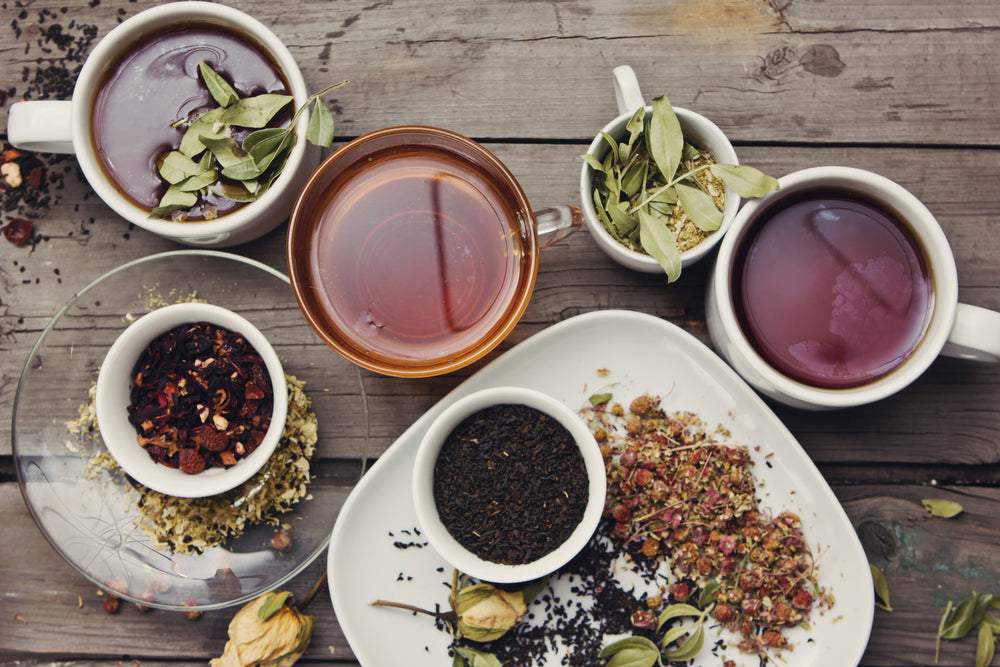 Different teas on wooden table.