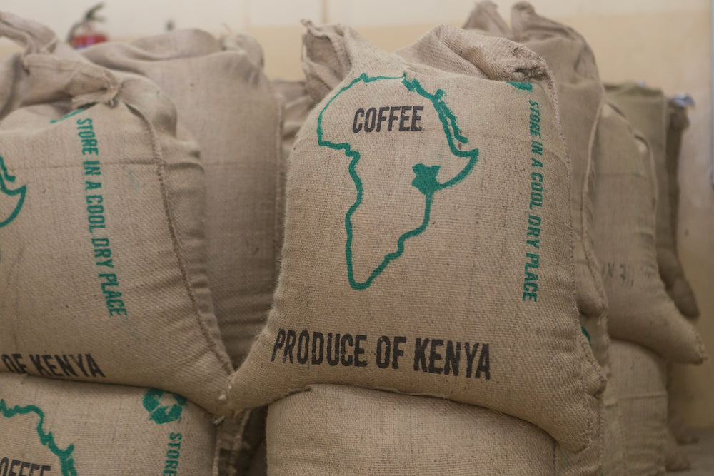 Burlap green coffee sacks with the outline of Kenya on the coffee sacks.