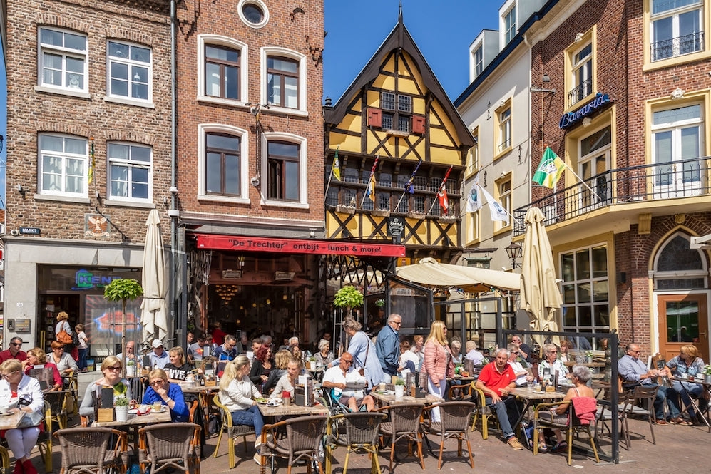 People enjoy the beautiful weather and coffee on the terrace in the center of Sittard, Netherlands.