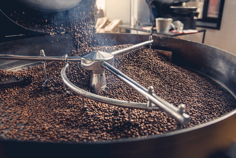 Roasted coffee beans turning in a cooling tray of a 45 kilo Probat coffee roaster.