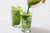Two tall glasses of Iced matcha lattes.