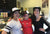 Weaver's Coffee & Tea coffee culture with three women baristas with their arms around each other in front of the espresso bar.