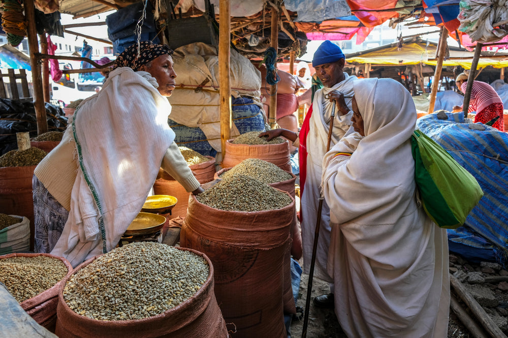 Woman selling coffee beans at the market in Ethiopia.